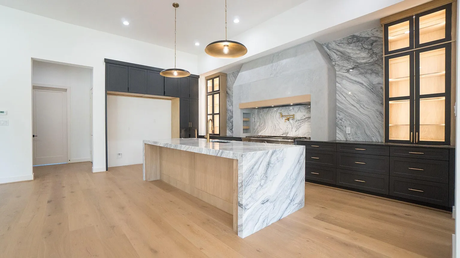 Novara kitchen with dark cabinetry and light counters