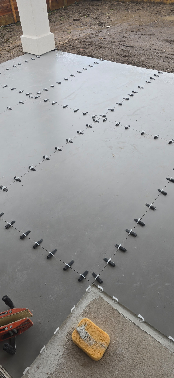 Tile leveling clips on a large-format tile floor
