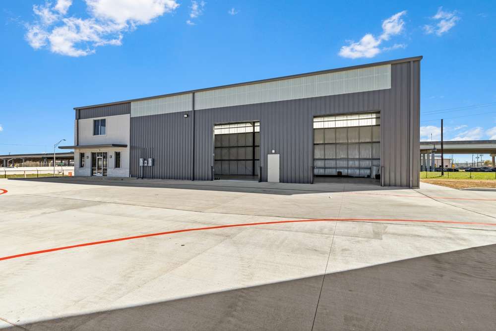 Completed Efficient Build metal flex building with storefront office entry and two drive-up bays, built by Novara Construction